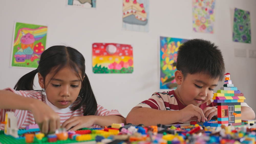 two children playing with LEGO