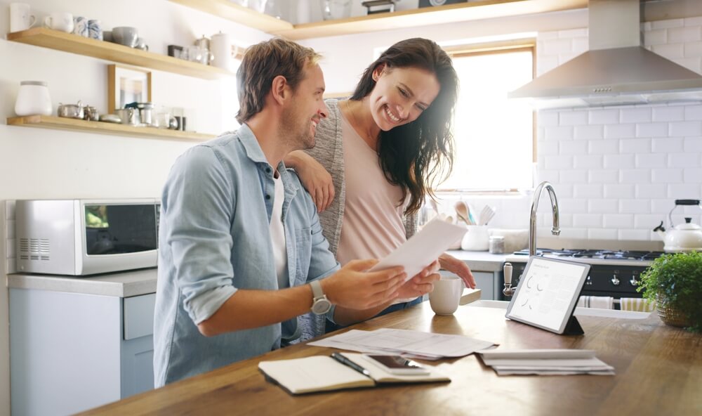 happy couple looking at home insurance
