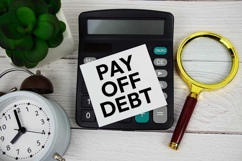 pay of debt written on paper