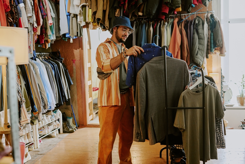 looking at zips on clothes in thrift store
