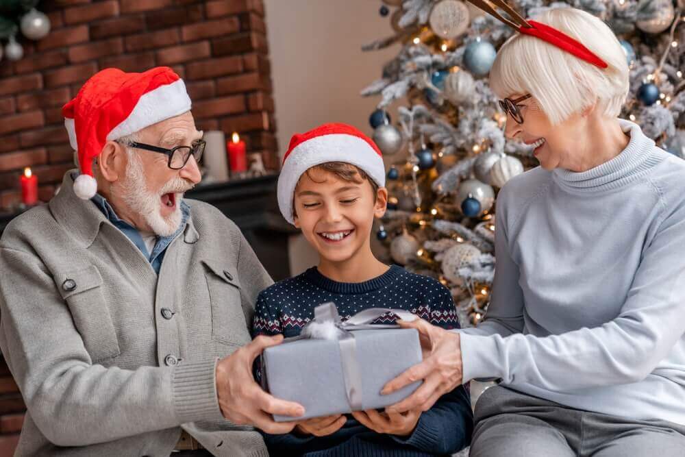 Grandchild with grandparents at Christmas