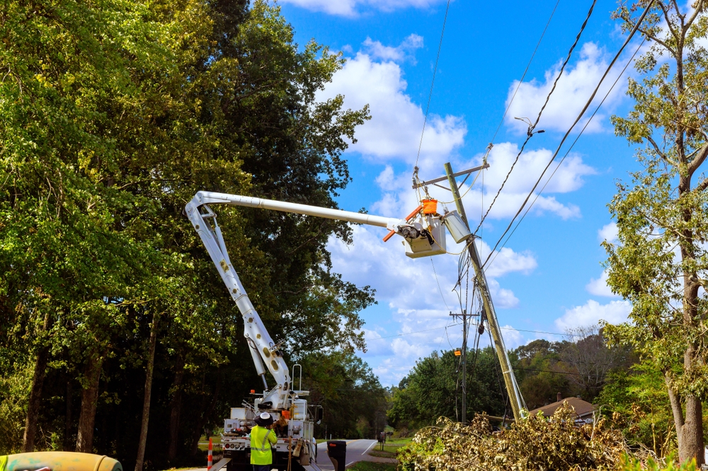 Utility crew using a bucket truck to repair overhead power lines