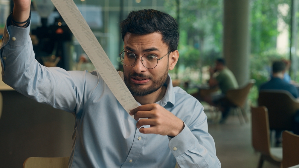 man with large restaurant bill