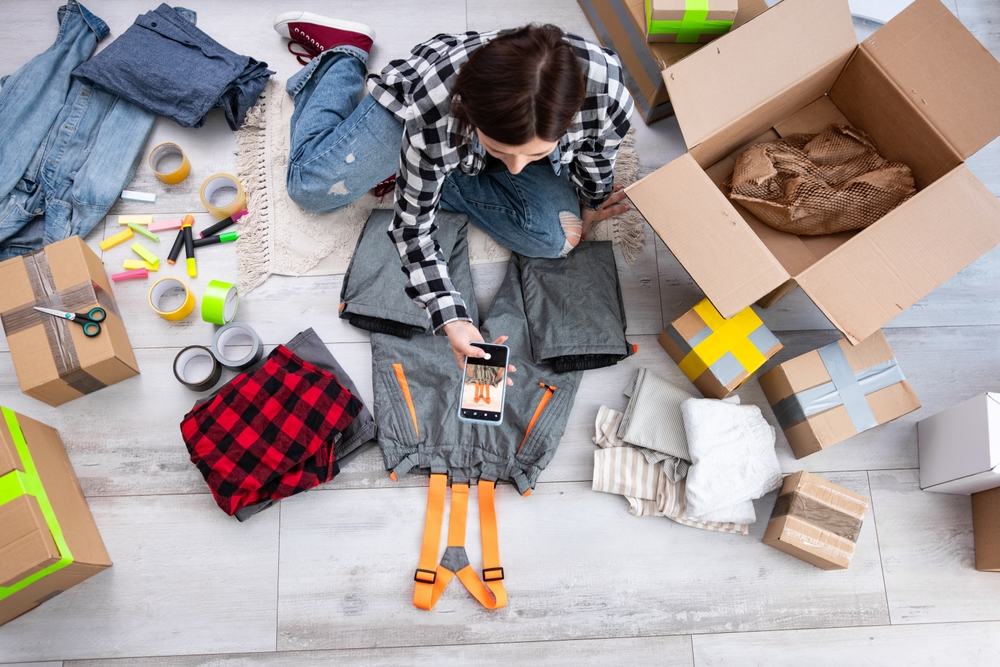 girl taking photos of clothes to sell online