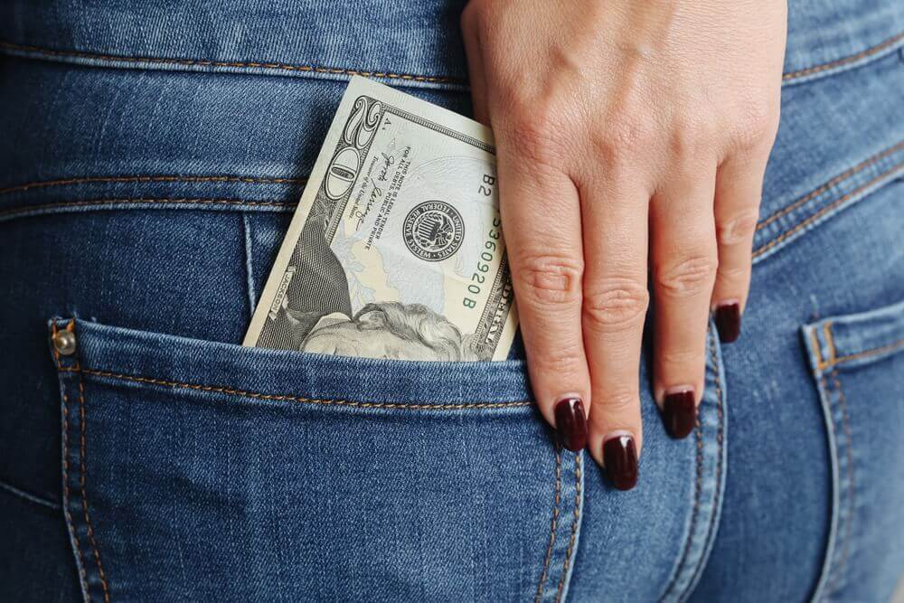 money in woman's back pocket