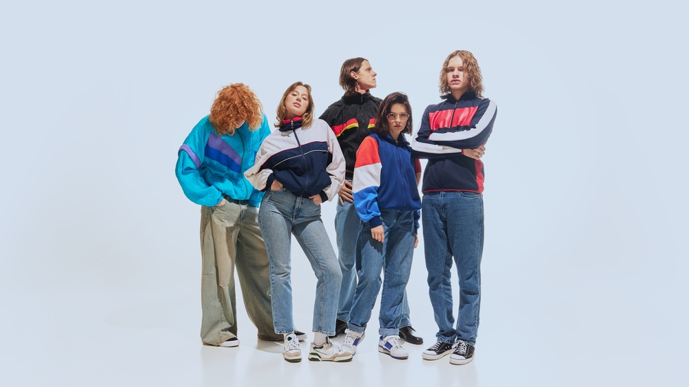 group of young people wearing vintage jackets and sneakers