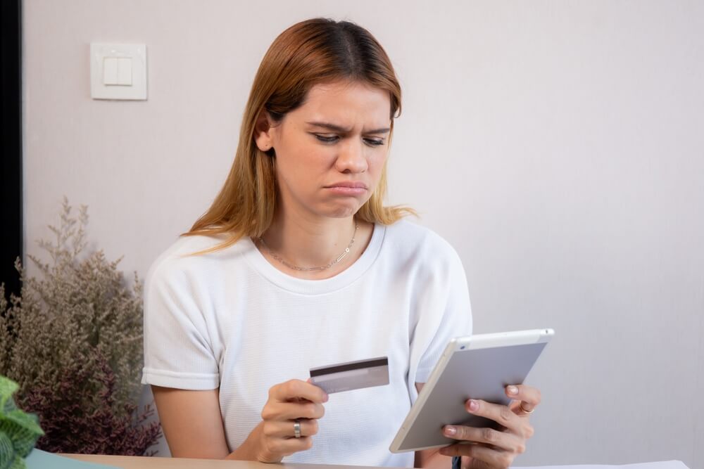 young woman worried about credit card bill