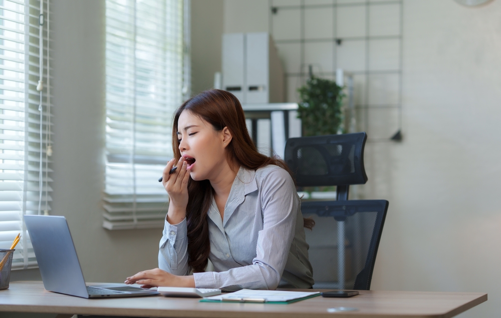 yawning at job behind a desk