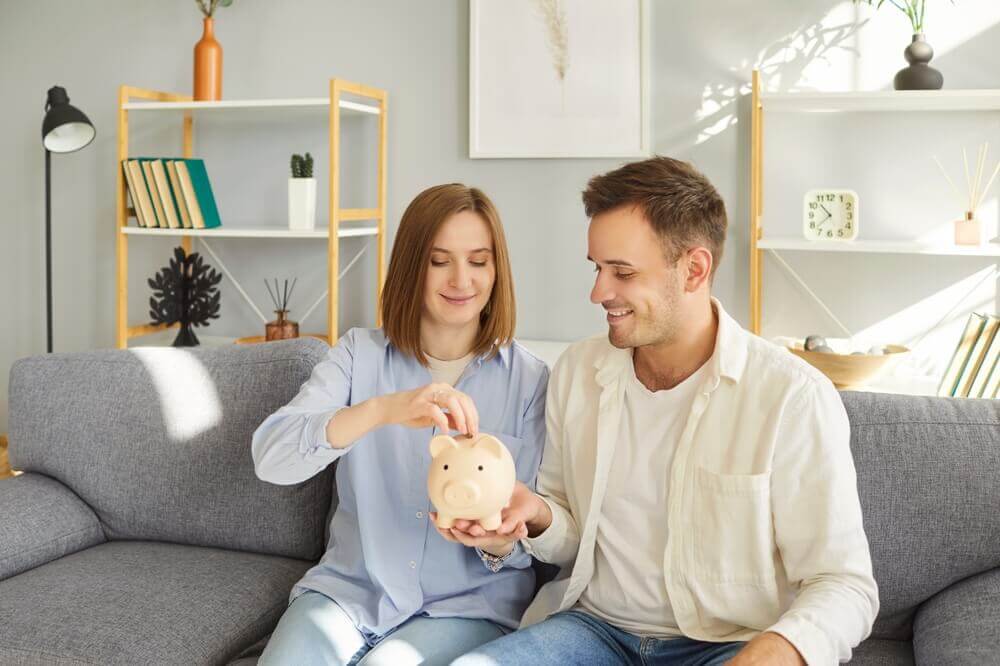 couple putting money in piggybank