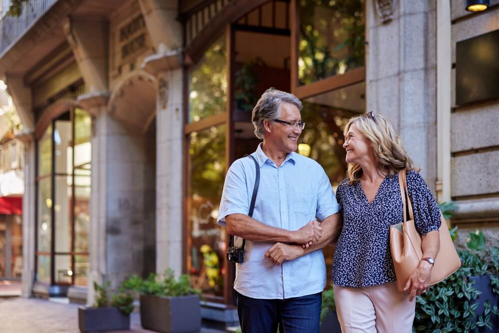 Senior couple walking downtown on sunny day