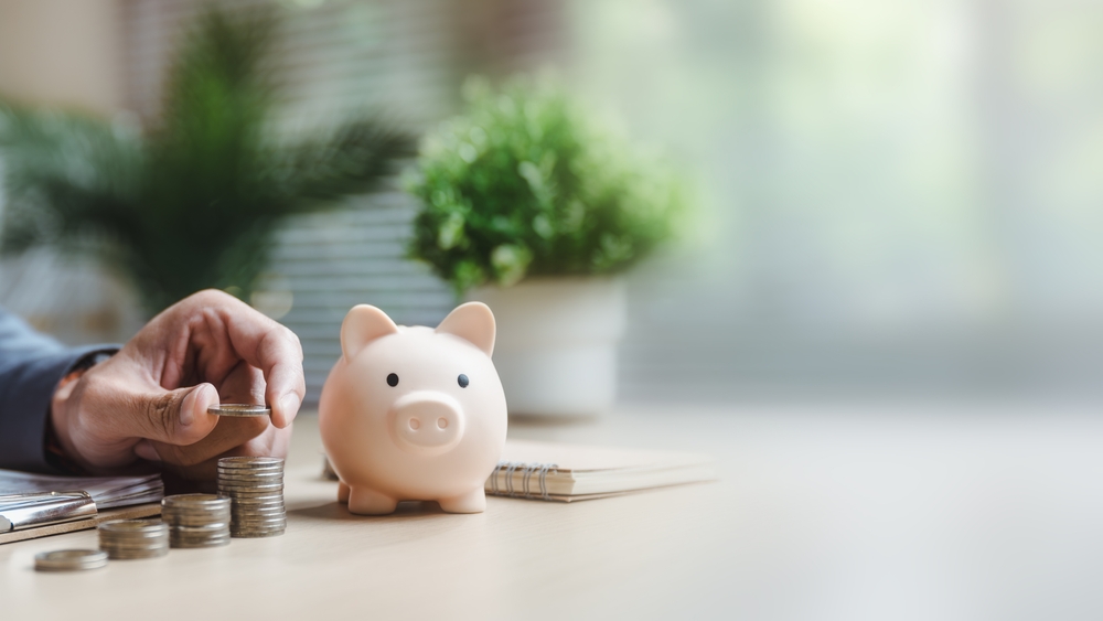 putting savings in a piggy bank