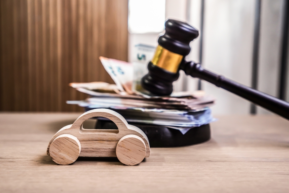 model car with gavel with money under it