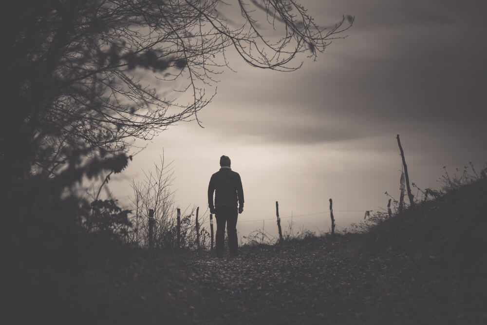 Silhouette of man in woods