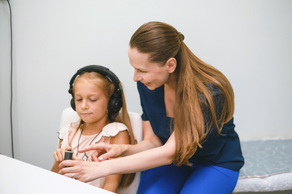 audiologist doing a hearing test on a child