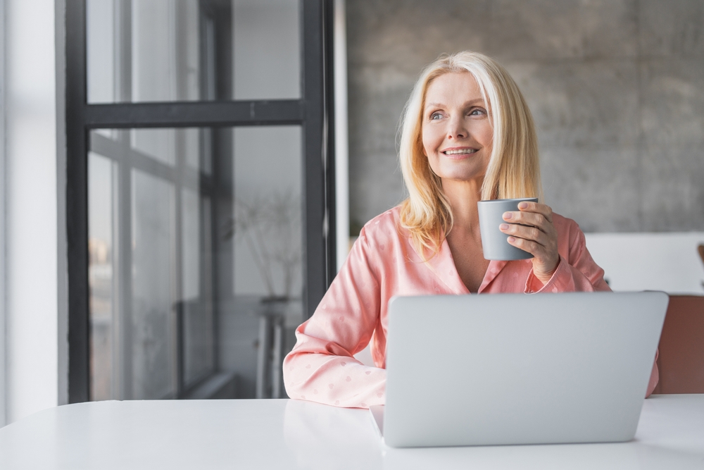 smiling 50 year old on computer