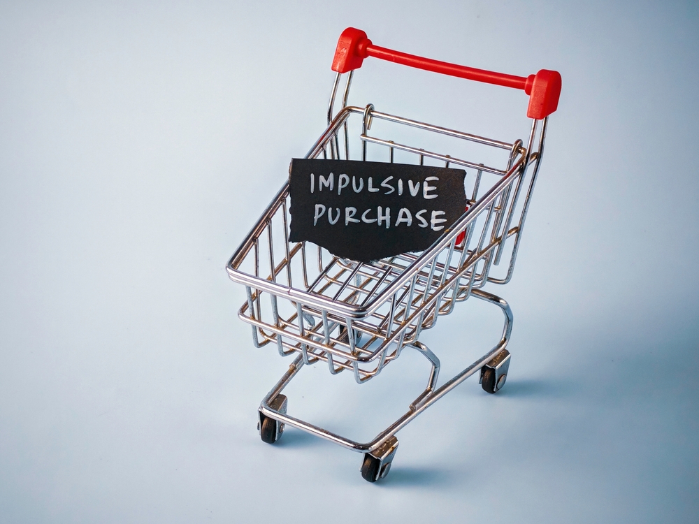 impulsive purchase written on chalk board in shopping trolley
