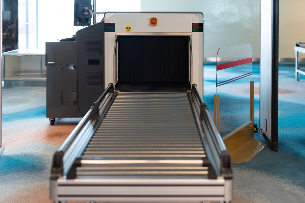 Conveyor belt leading into an airport security baggage scanner