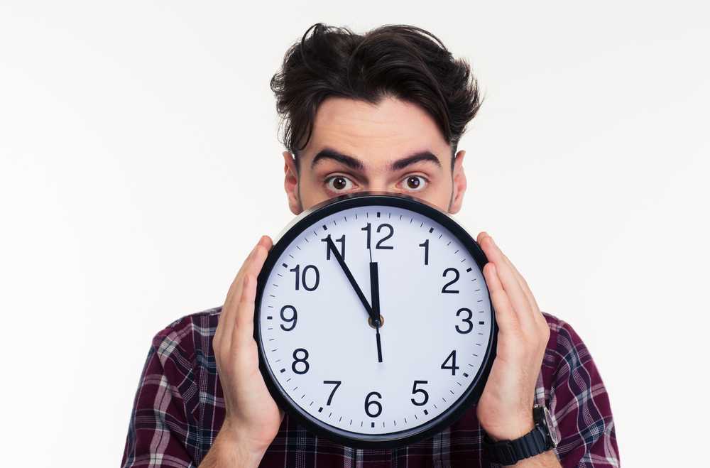 man holding a clock