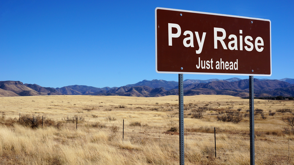 pay raise road sign
