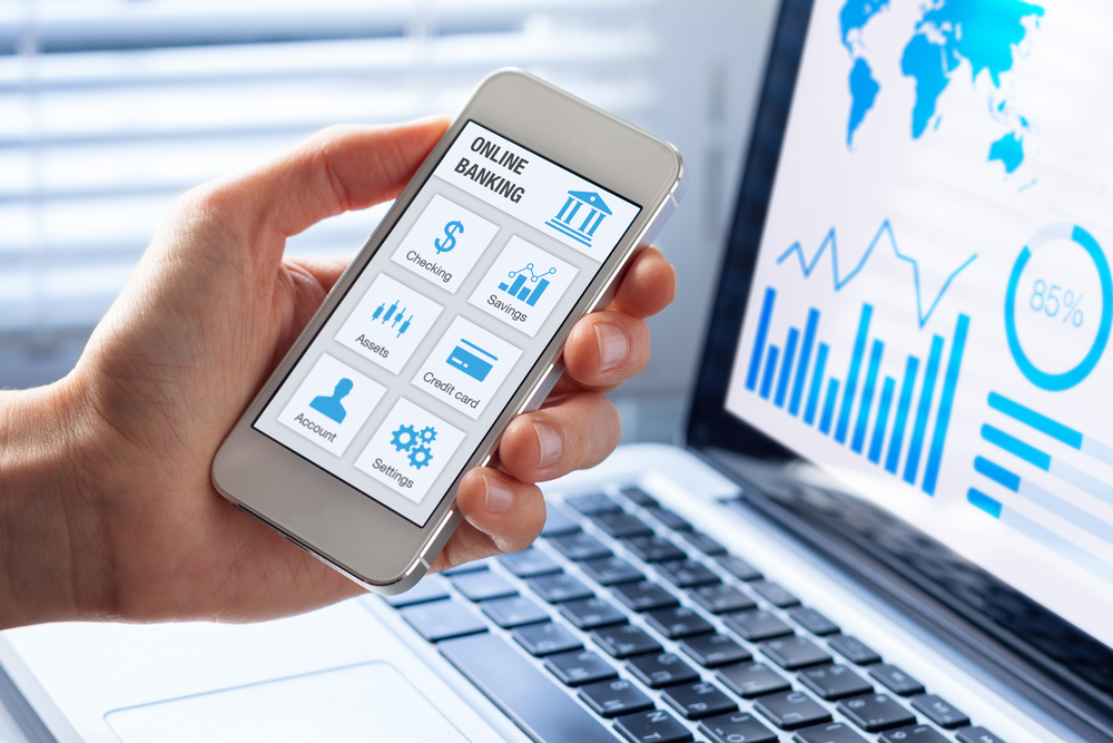 Hand holding a smartphone with online banking account options