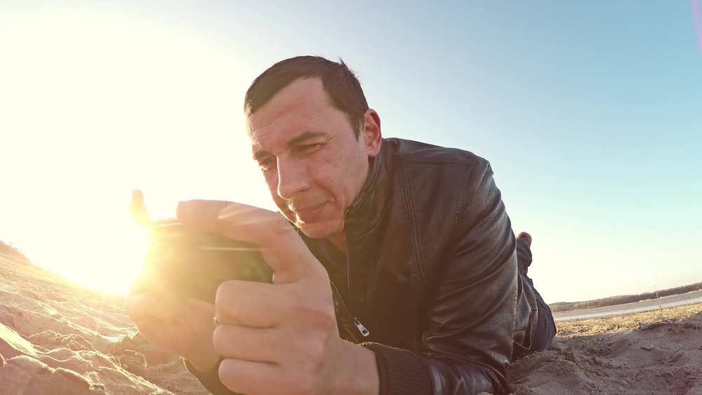 Playing PSP on beach