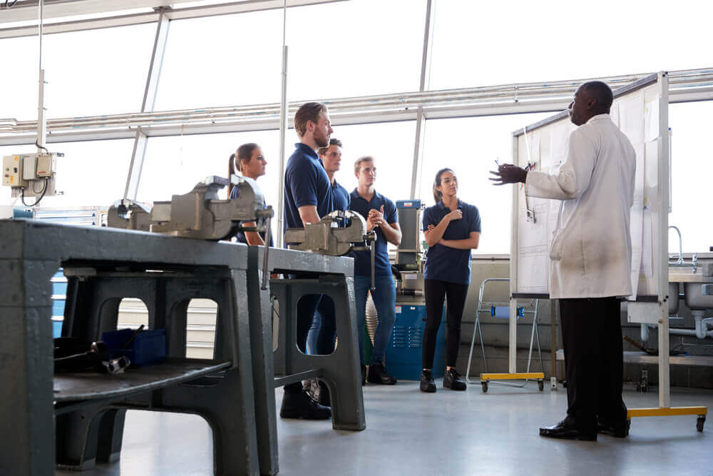 Group in classroom-style training with equipment