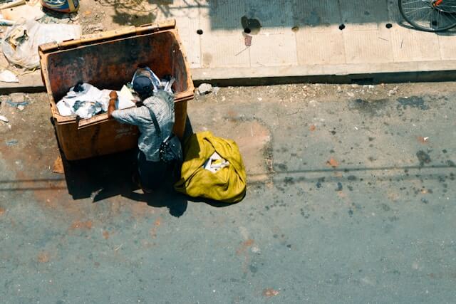 looking though a dumpster