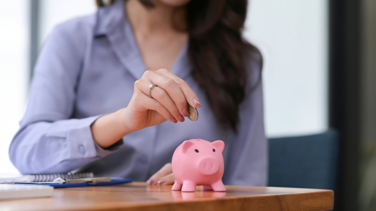 woman saving money in a piggy bank