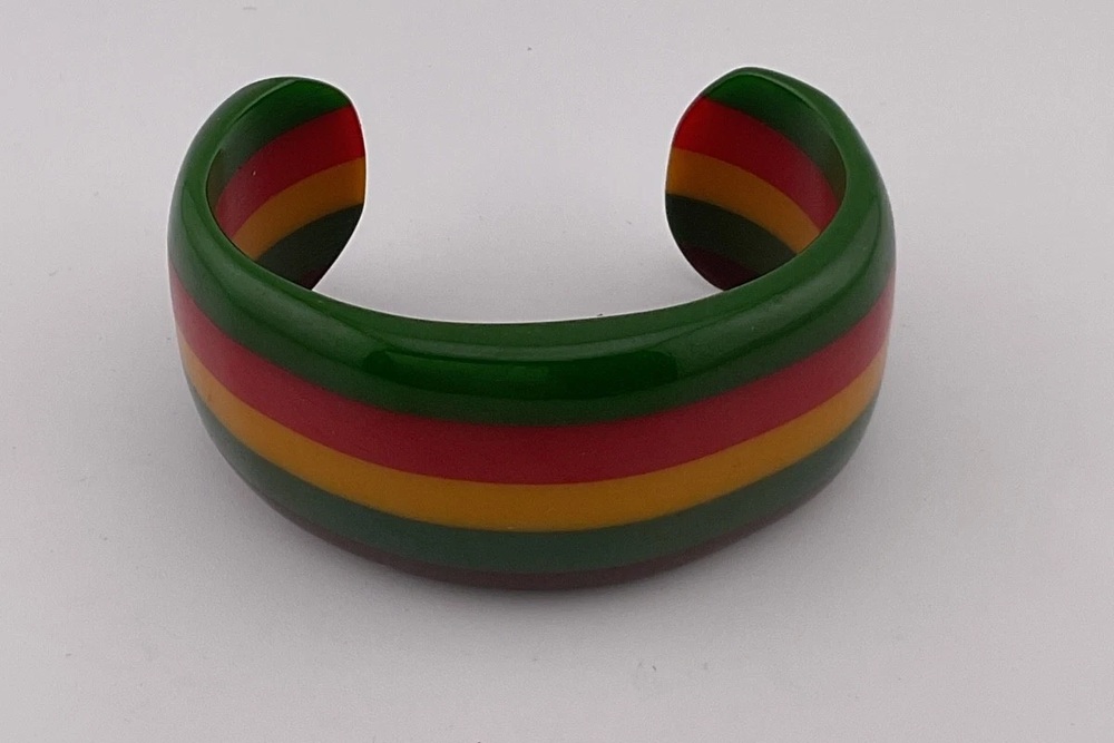 Open Bakelite cuff with laminated green, red, yellow and brown color bands