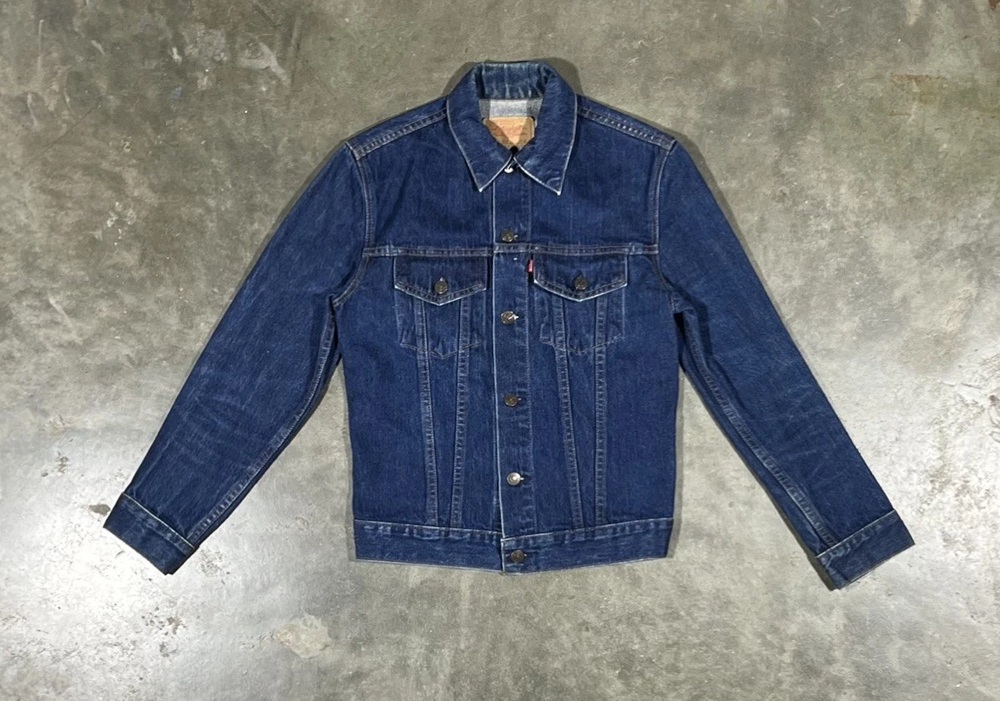 Small-e Levi's Type III denim trucker jacket laid flat on a gray background