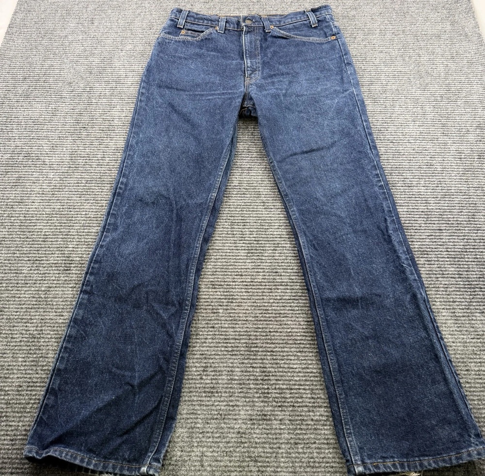 Vintage Orange Tab Levi's jeans with flared legs on a gray background
