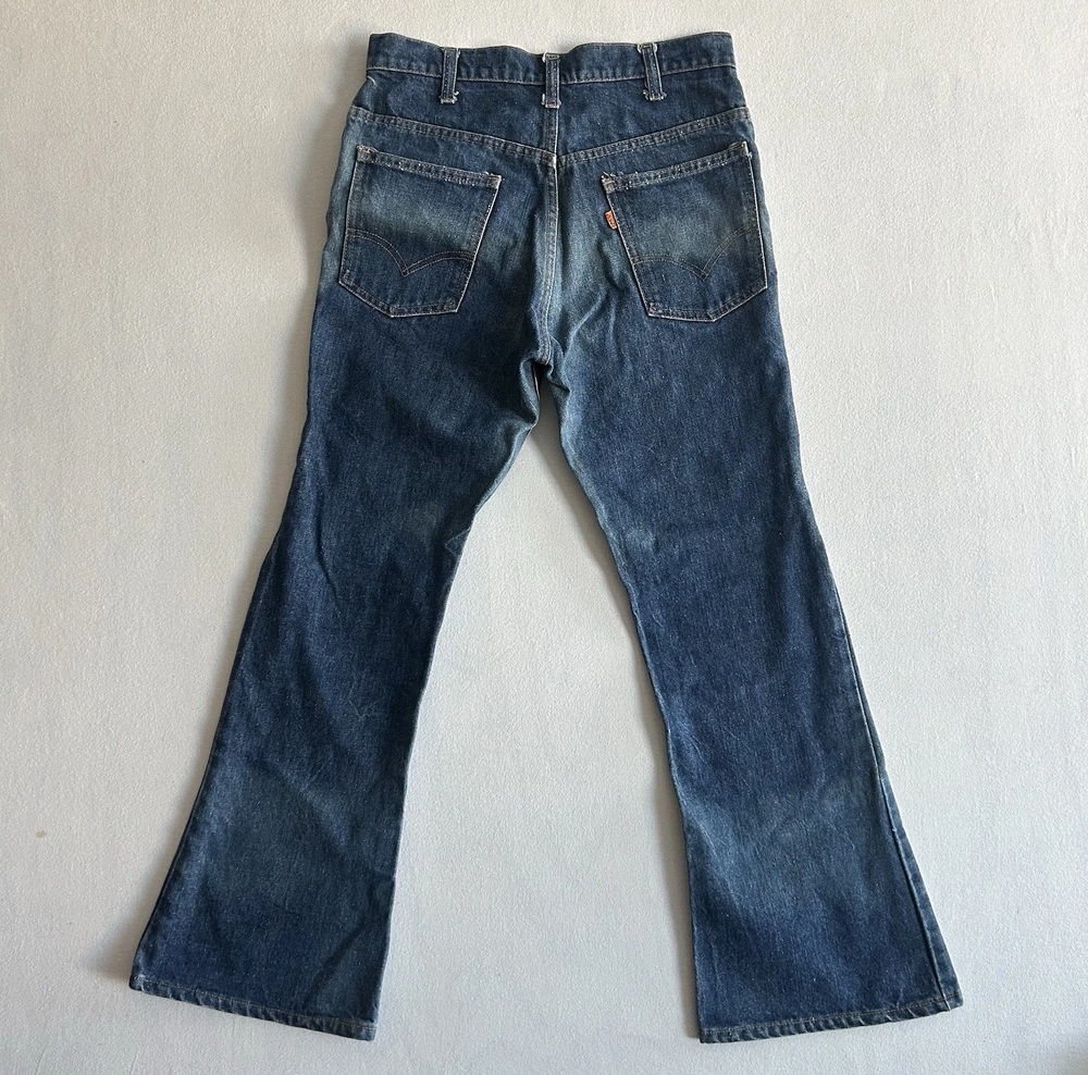 Back of original 1977 Levi's 646 bell-bottom jeans showing the orange pocket tab and flared legs
