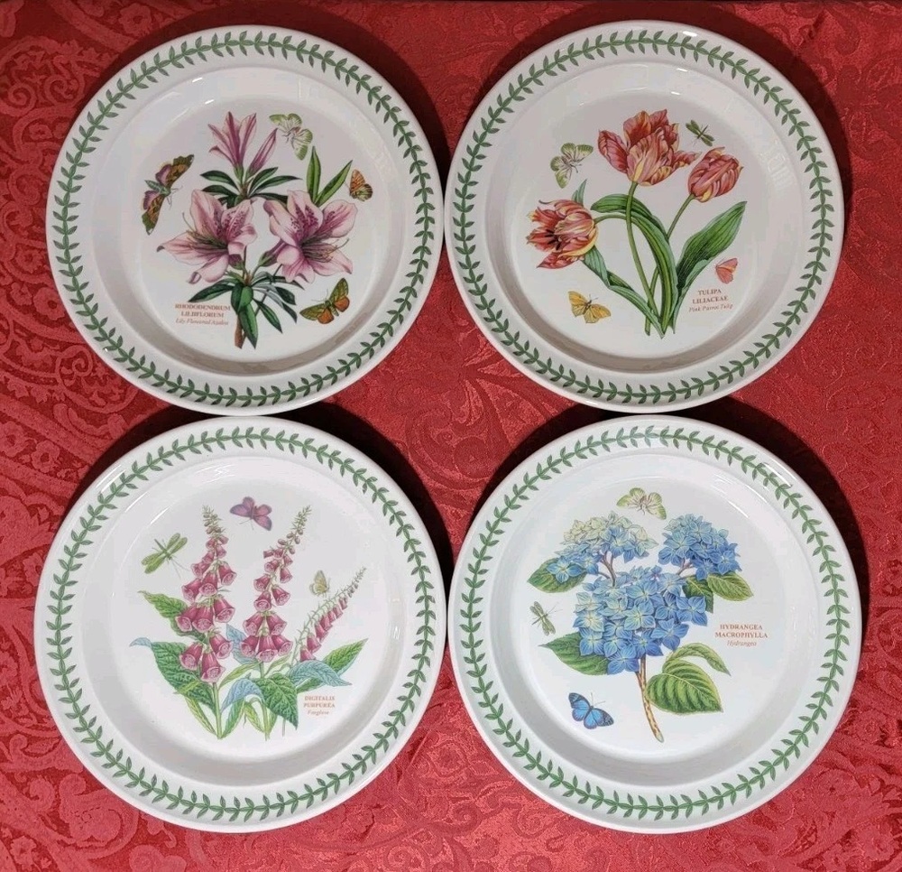 Four Portmeirion Botanic Garden plates with floral centers and leafy borders