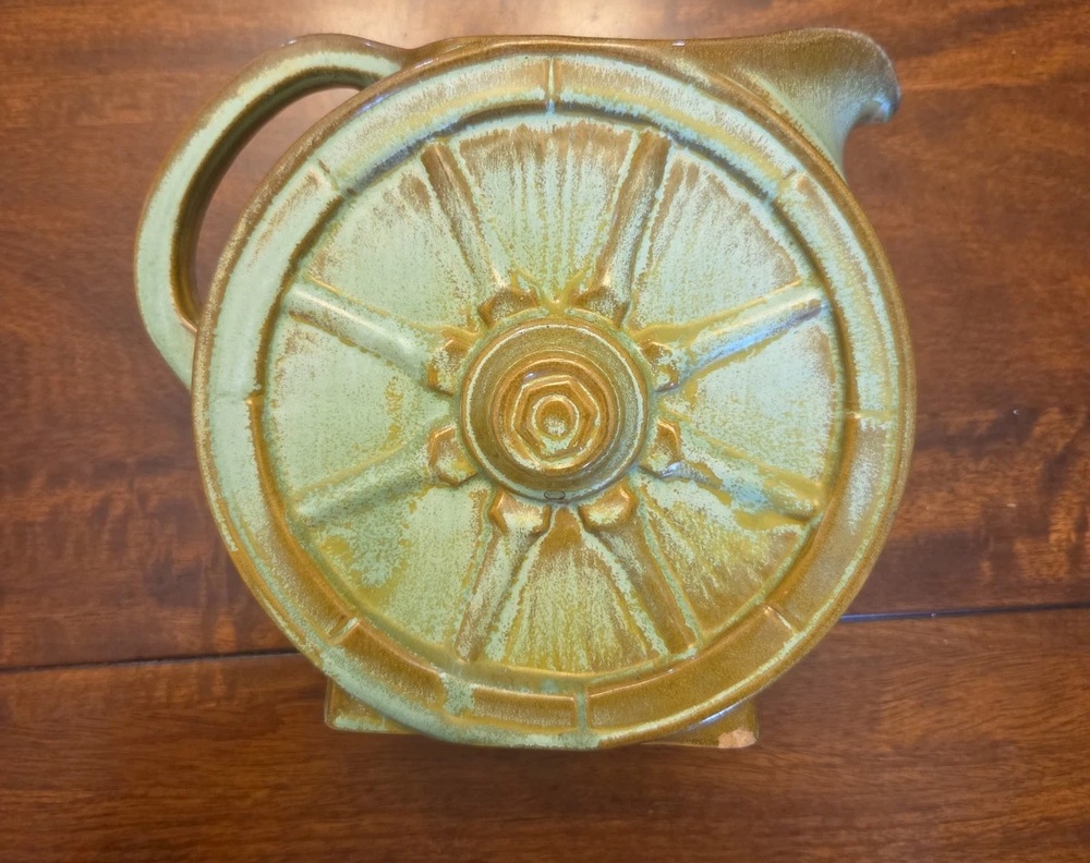 Prairie Green Frankoma Wagon Wheel pitcher with a raised wheel design