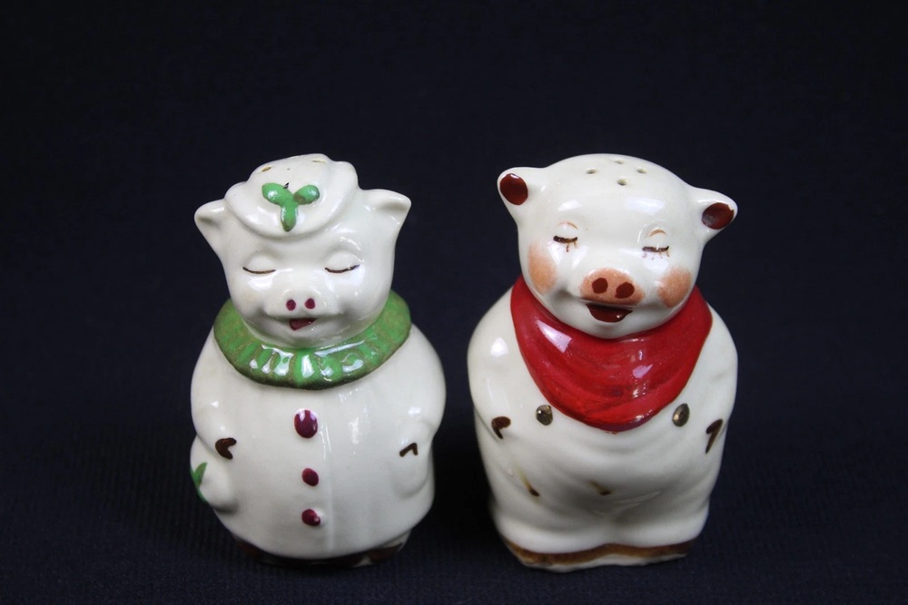 White Shawnee pig shakers wearing green and red neckerchiefs.