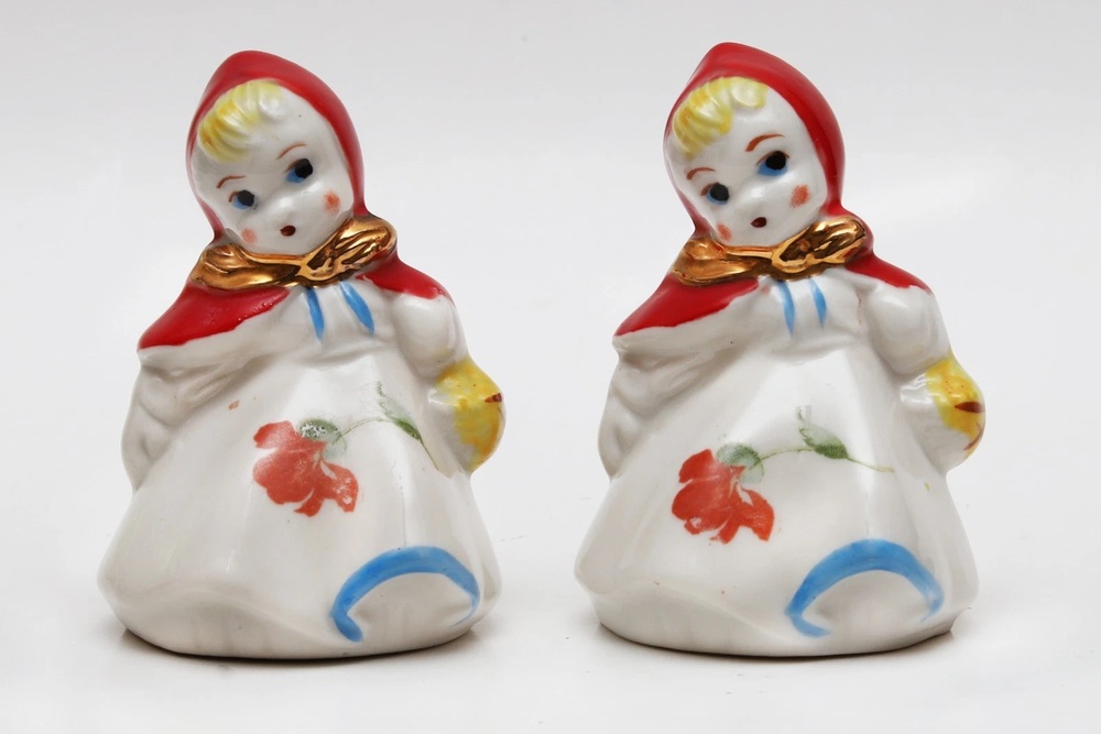 Two Hull Little Red Riding Hood shakers with red hoods and floral dresses.