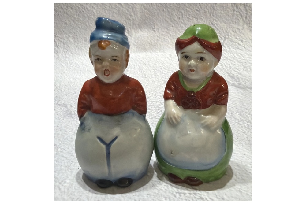 Occupied Japan Dutch boy and girl shakers with red tops and white clothing.