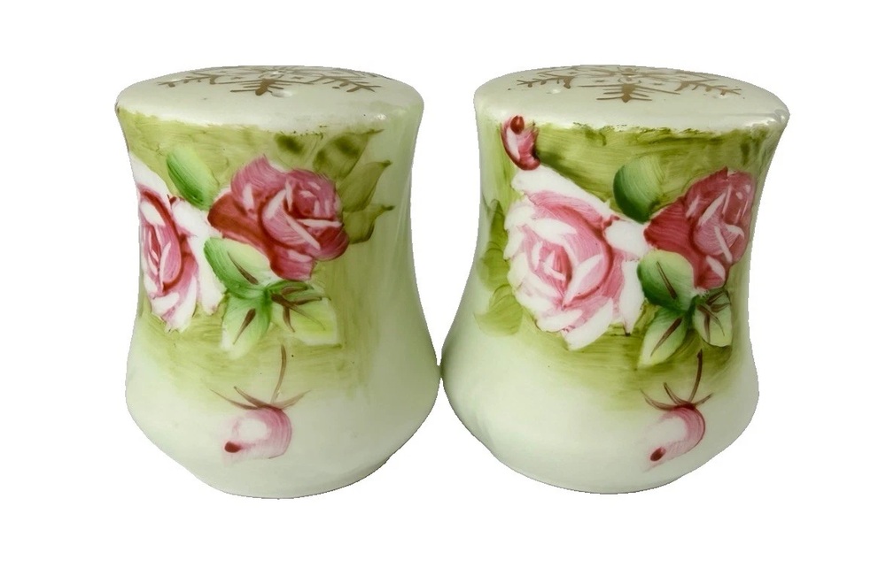 Lefton ceramic shakers painted with pink roses and green leaves.