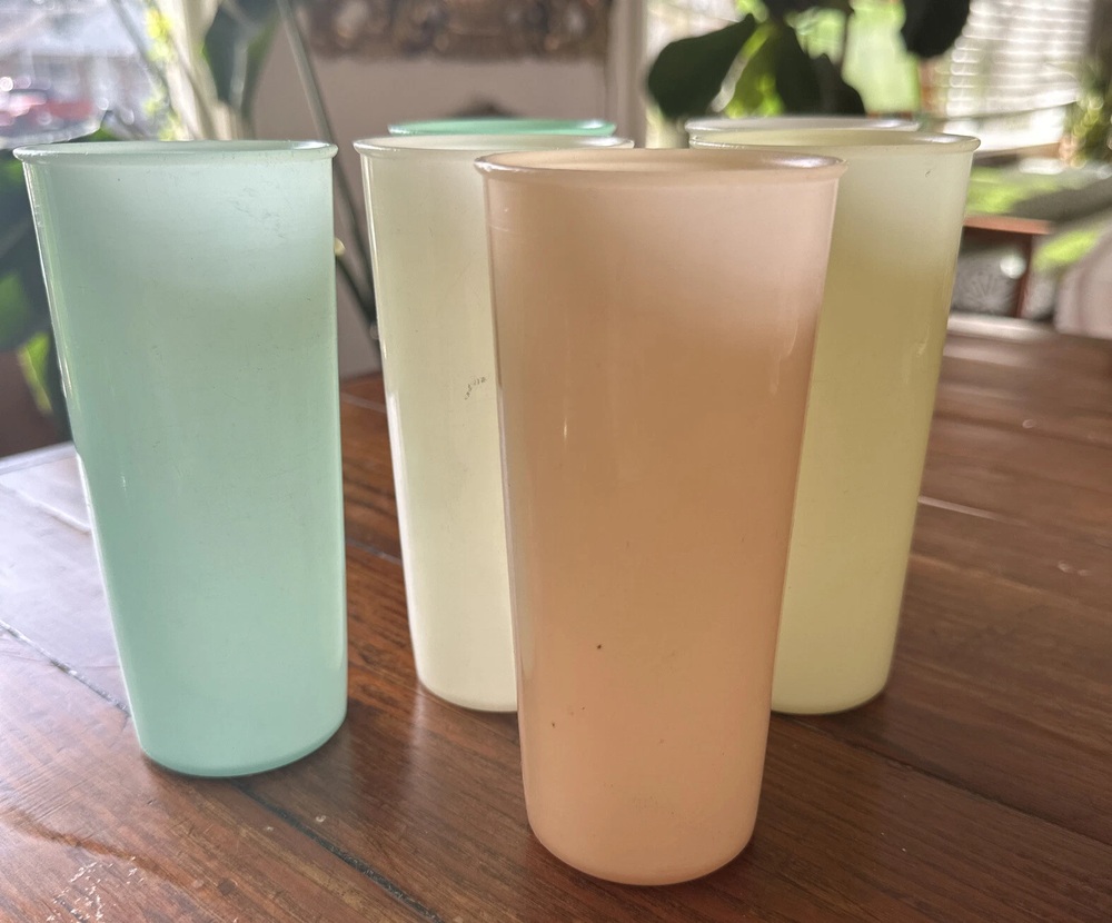 Six tall Tupperware tumblers in sheer pastel colors