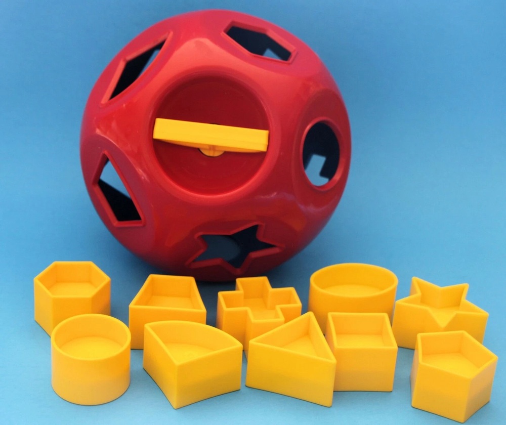 Red and blue Tuppertoys Shape-O Ball with yellow shapes