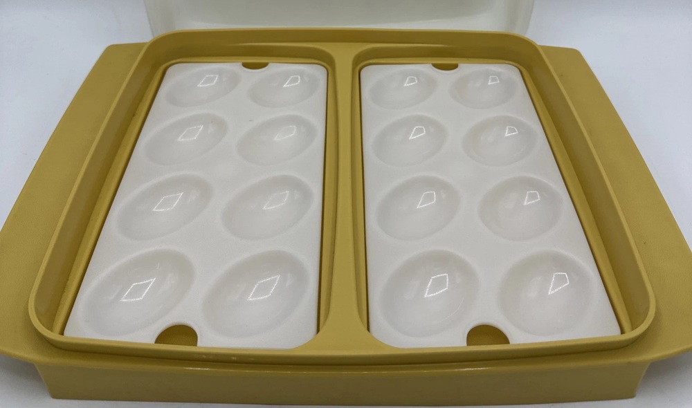 Harvest gold Tupperware egg keeper with two white egg trays